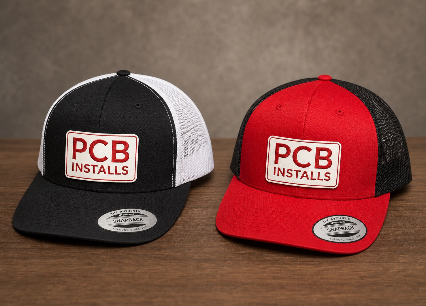 Black and red hats with custom PCB Installs logo patches, made by KM2.