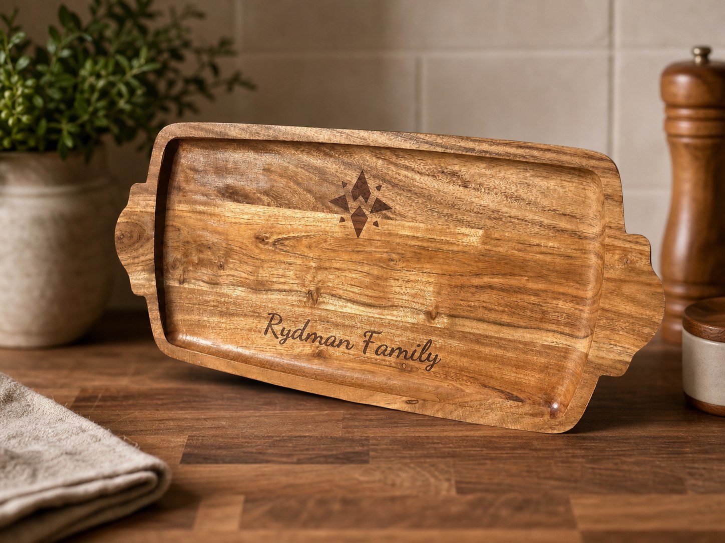 Wood serving board engraved with the Rydman family name.